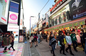 Video game developers walking through a Japanese city
